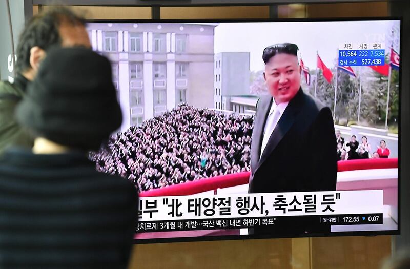 People watch a television news broadcast showing file footage of North Korean leader Kim Jong Un, at a railway station in Seoul on April 14, 2020. North Korea fired several suspected cruise missiles on April 14 towards the sea, according to the South's military, with analysts saying Pyongyang was demonstrating the breadth of its arsenal. / AFP / Jung Yeon-je
