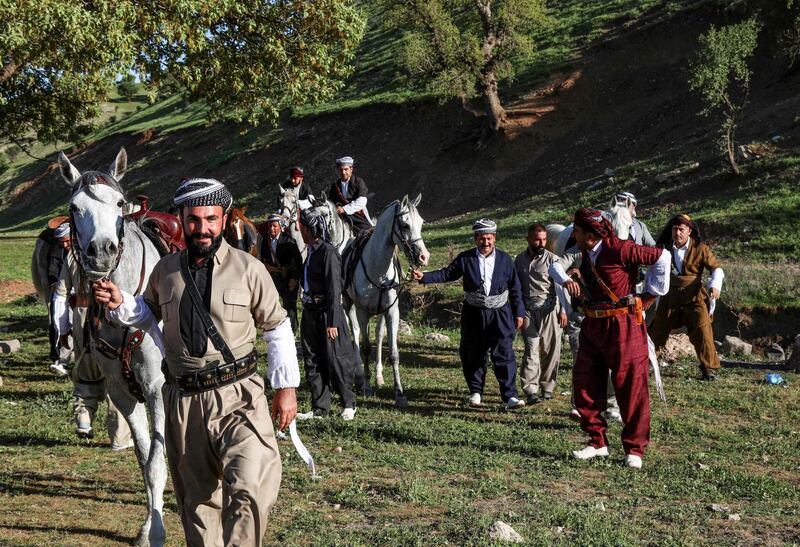 Men walk with their horses during the annual Iraqi Kurdish Spring Cultural Festival in Erbil, the capital of the Kurdistan Region, Iraq. AFP