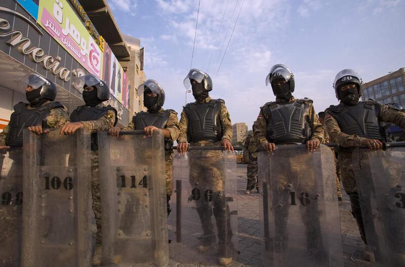 Iraqi riot police stand guard in Basra.  AFP