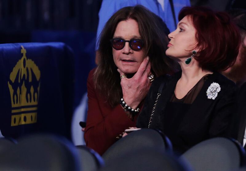 Ozzy Osbourne, left, and his wife Sharon wait for the super welterweight boxing match. AP