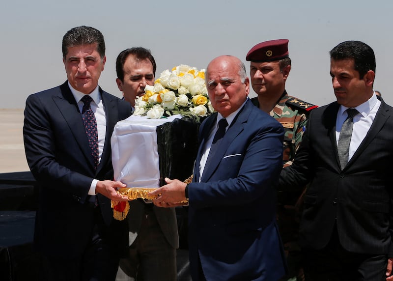 President of the Kurdistan region in Iraq Nechirvan Barzani carries the coffin of an Iraqi killed in an attack on a mountain resort in Iraq's northern province of Dohuk. Reuters