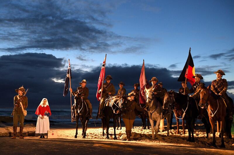 Australian military veterans participate in the ANZAC Day dawn service at Elephant Rock in Currumbin on the Gold Coast, Australia, Wednesday, April 25, 2018. Thousands of Australians gathered at pre-dawn services around the country to commemorate the moment when Australian and New Zealand Army Corps troops waded ashore at the Gallipoli peninsula in Turkey 103 years ago in their first major battle of World War I. (Dave Hunt/AAP Image via AP)