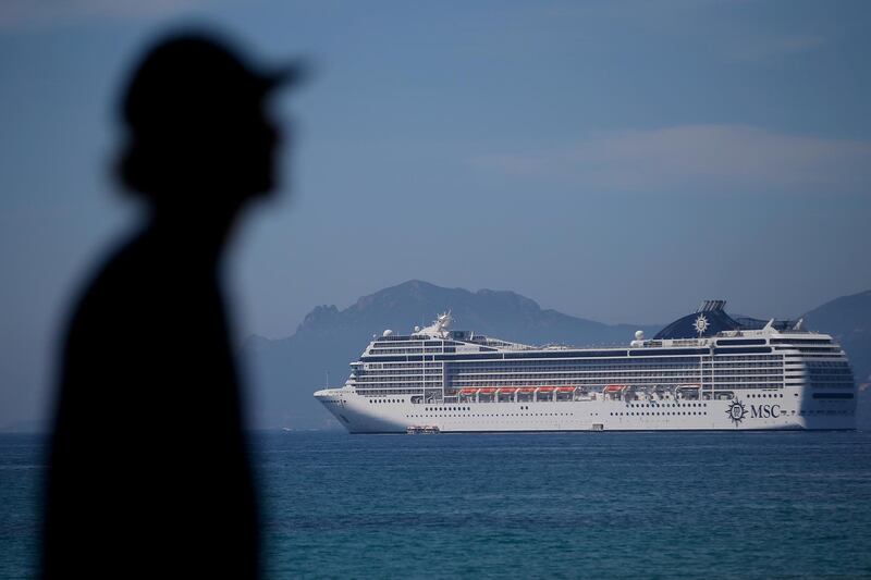 FILE PHOTO: 70th Cannes Film Festival - Cannes, France. 15/05/2017 - A man walks on the Croisette as the MSC Orchestra Cruise ship is seen in the bay before the start of the festival. REUTERS/Stephane Mahe/File Photo