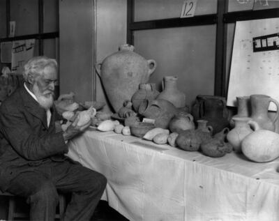 Flinders Petrie examining pottery discovered by him on a journey to the ancient city of Abraham. Getty Images