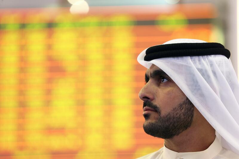 An Investor looks at the screen at the Dubai International Financial Market in Dubai. Reuters