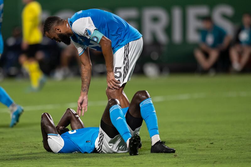 Charlotte defender Anton Walkes checks on midfielder Derrick Jones after a collision. AP