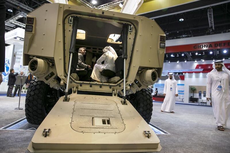 People check out the newly-unveiled Enigma 8x8 armoured all-terrrain vehicle at Idex. Silvia Razgova / The National