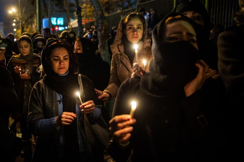 Demonstrators hold candles while gathering during a vigil for the victims of the Ukraine International Airlines flight that was unintentionally shot down by Iran, in Tehran, Iran. Bloomberg