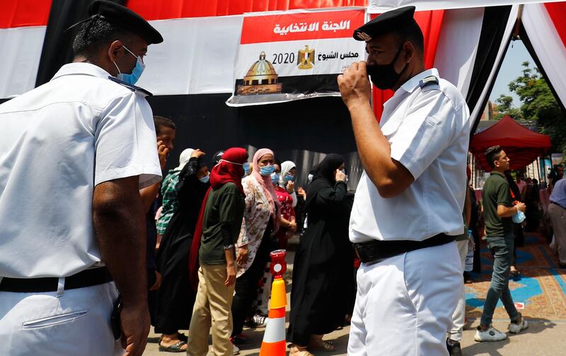 Egyptians, queue up outside a polling station on for a new senate in an upper house election. AFP