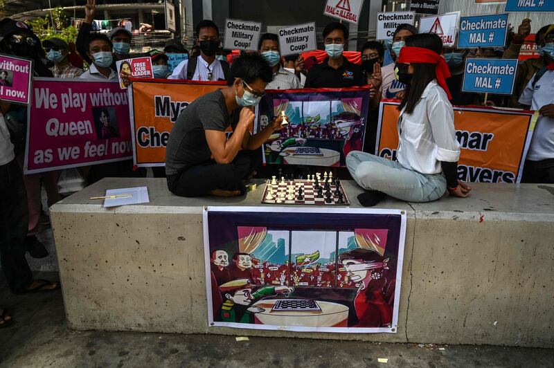 Protesters perform a chess game, with one of the players being blindfolded, during a demonstration against the military coup in Yangon. AFP