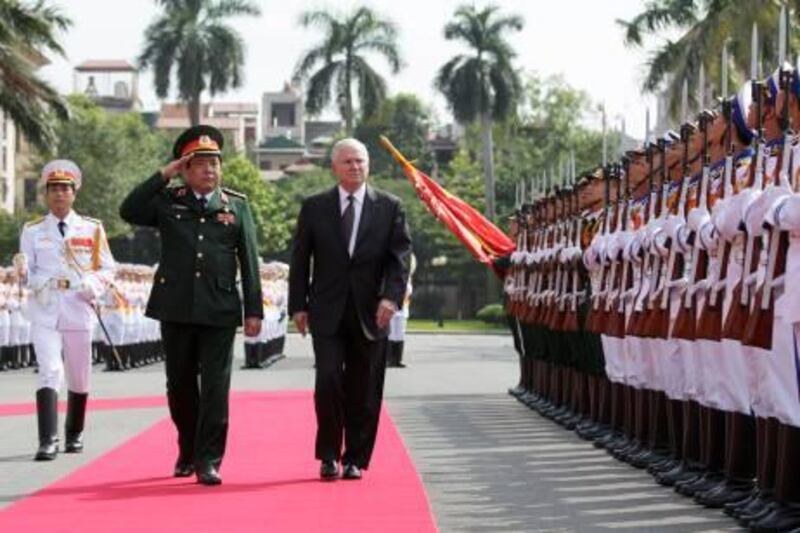 Defense Secretary Robert Gates, right, revies Guards of Honor with Vietnam's Minister of Defense General Phung Quang Thanh at the Vietnam Ministry of Defense in Hanoi, Vietnam, Monday, Oct. 11, 2010.  (AP Photo/Carolyn Kaster, Pool) *** Local Caption ***  VNMK119_Gates.jpg