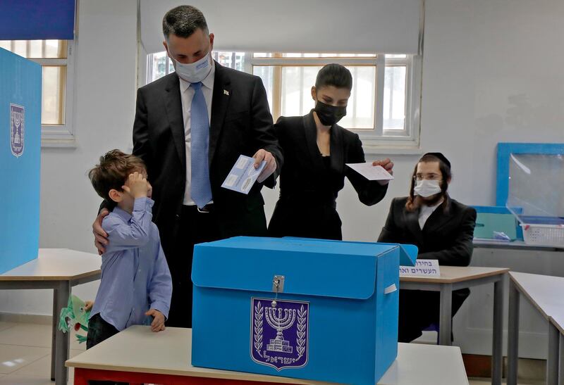 Chairman of Israel's New Hope party Gideon Saar and his wife Geula vote with their children at a polling station in the coastal city of Tel Avivi. EPA