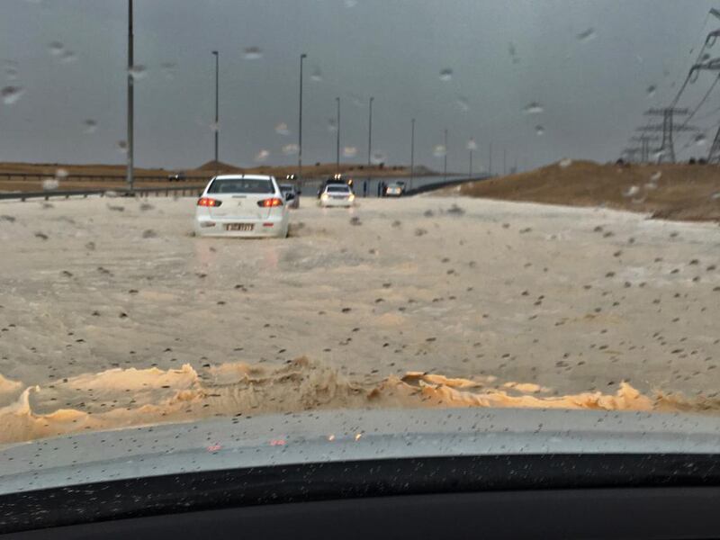 Brian Kleiver, an American living in Abu Dhabi, had to push his car to higher ground after his car got stuck in rainwater. Courtesy Brian Kleiver