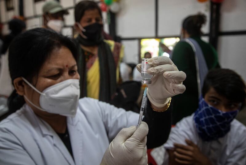 A health worker prepares to vaccinate a teenager in Gauhati, India. On Monday, state governments across the country administered doses at schools, hospitals and special vaccination sites amid a rapid rise in coronavirus infections. AP Photo