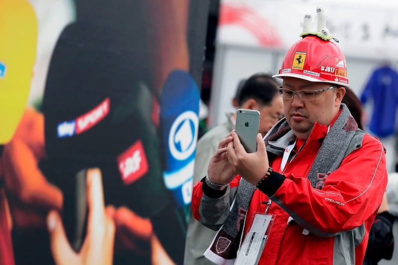 A fan takes a photo before the first practice round of the Grand Prix at the Suzuka circuit. Kiyoshi Ota / AFP Photo.