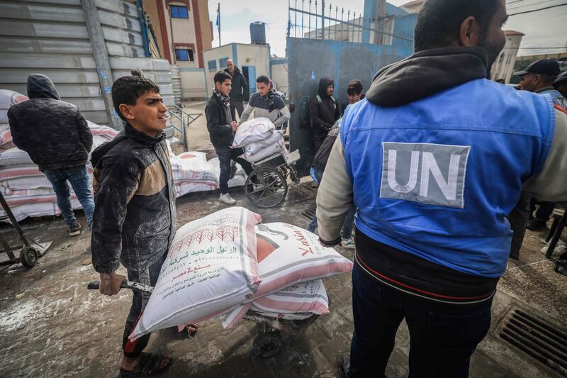 Displaced Palestinians receive food aid at the UNRWA centre in Rafah in southern Gaza. AFP