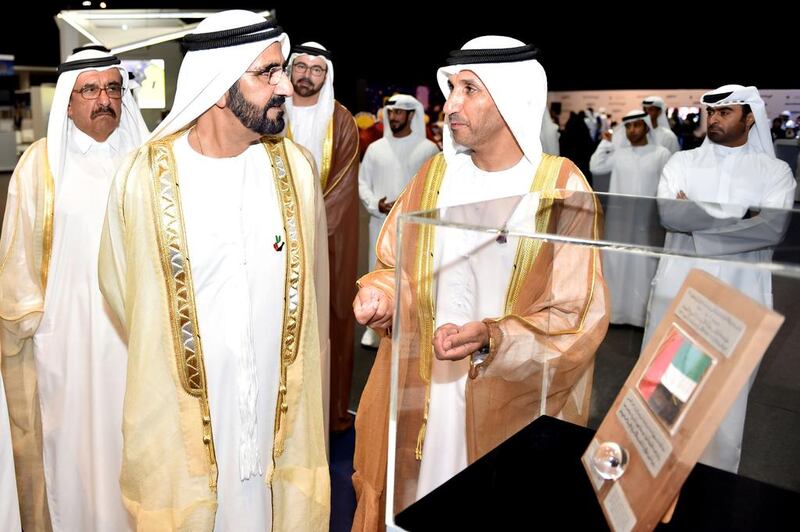 Sheikh Mohammed bin Rashid, Vice President and Ruler of Dubai, looks at the UAE flag that was carried to the moon by Apollo 17 in 1973. Wam