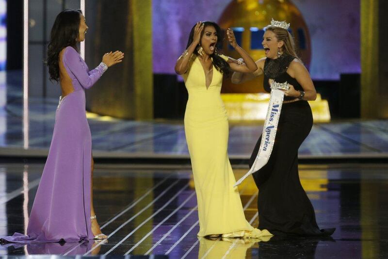 Miss New York Nina Davuluri, center, reacts after being named Miss America 2014 pageant as Miss California Crystal Lee, left, and Miss America 2013 Mallory Hagan celebrate with her in Atlantic City, N.J. AP Photo/Mel Evans