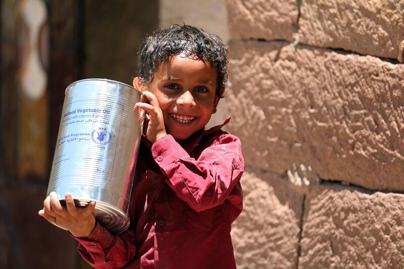 A Yemeni child receives humanitarian aid, donated by the World Food Programme in the city of Taez, on October 10. Ahmad Al Basha / AFP