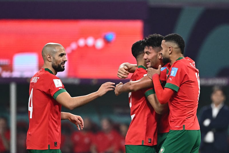 Achraf Dari (2R) celebrates with teammates. AFP