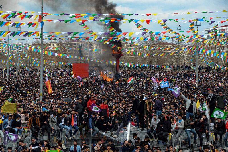 Turkish Kurds in Diyarbakir, southeastern Turkey, gather around a bonfire during Nowruz celebrations marking the Persian New Year. AFP