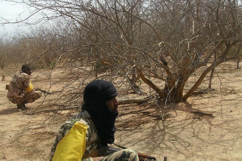 (FILES) In this file photo taken on July 18, 2011 Malian troops check bushes, three weeks after a military raid dislodged Al-Qaeda in the Islamic Maghrab (AQIM) from its newly-built base in the Wagoudou forest.  One of Mali's top jihadist leaders Amadou Koufa has died after a raid led by French soldiers in the centre of the troubled country, Malian and French authorities confirmed on November 24, 2018. / AFP / SERGE DANIEL

