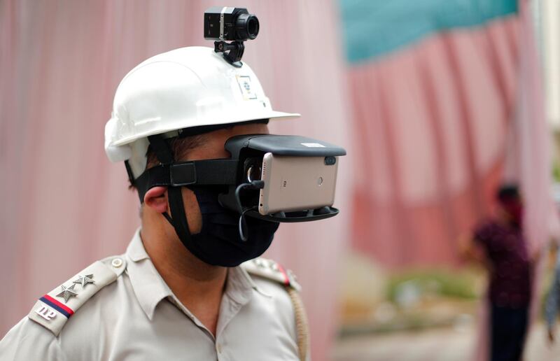 A police officer wears a headgear mounted with thermal temperature monitor during a nationwide lockdown to slow the spread of the coronavirus, in New Delhi, India. Reuters