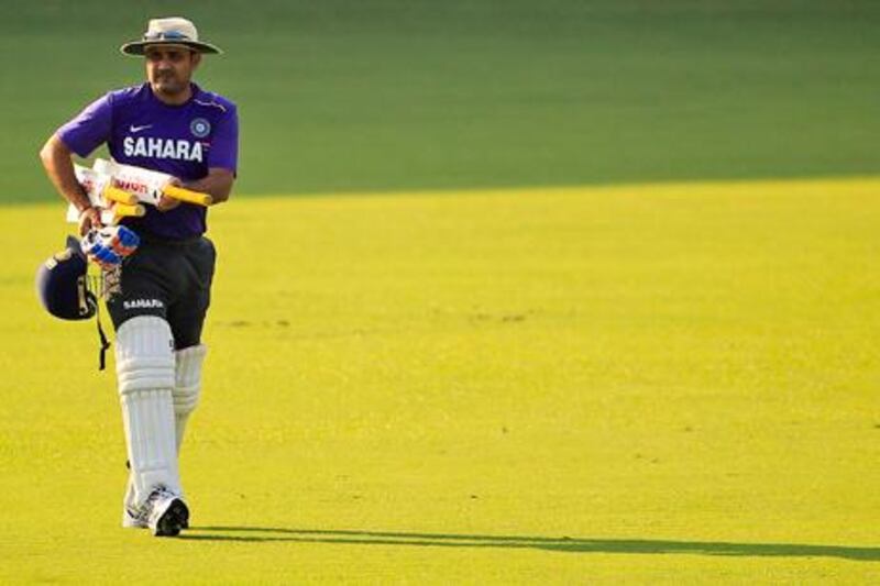 India's Virender Sehwag attends a cricket practice session in Mumbai, India, Friday, Nov. 9, 2012. (AP Photo/Rajanish Kakade)