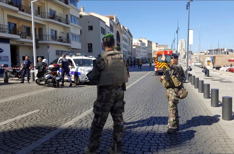 Armed soldiers on the scene after a van rammed into two bus stops in Marseille. David Coquille via AP
