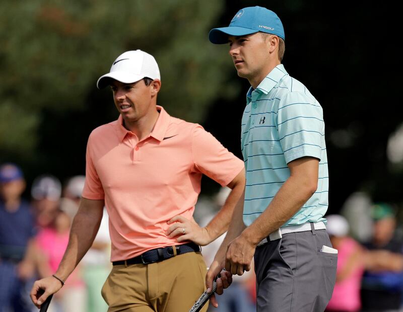 Jordan Spieth, right, talks with Rory McIlroy, from Northern Ireland, on the first hole during the second round of the Bridgestone Invitational golf tournament at Firestone Country Club, Friday, Aug. 4, 2017, in Akron, Ohio. (AP Photo/Tony Dejak)