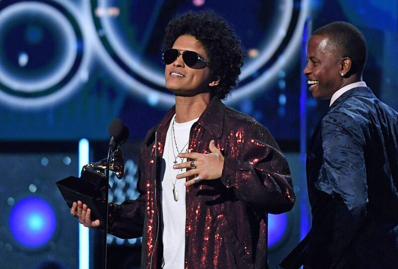 (FILES) In this file photo taken on January 28, 2018 Bruno Mars receives a second Grammy for Record of the Year during the 60th Annual Grammy Awards show in New York.  The Grammys will expand the number of nominees in main categories for music's most prestigious awards as organizers try to counter a backlash over how few women and minorities are winning. In one of the biggest changes at the Grammys in years, the Recording Academy -- which administers the prizes -- said June 26, 2018 in a letter to members that next year's awards will boost the field of hopefuls from five to eight for the top four categories. / AFP / Timothy A. CLARY  
