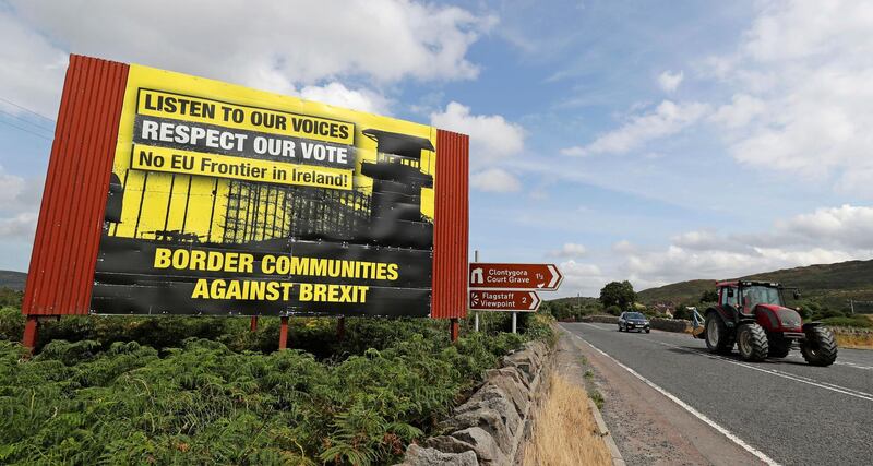Anti Brexit billboards are seen on the northern side of the border between Newry, in Northern Ireland, and Dundalk, in the Republic of Ireland, on Wednesday, July 18, 2018. British Prime Minister Theresa May is scheduled to make her first visit to the Irish border since the Brexit referendum later this week.  (Niall Carson/PA via AP)