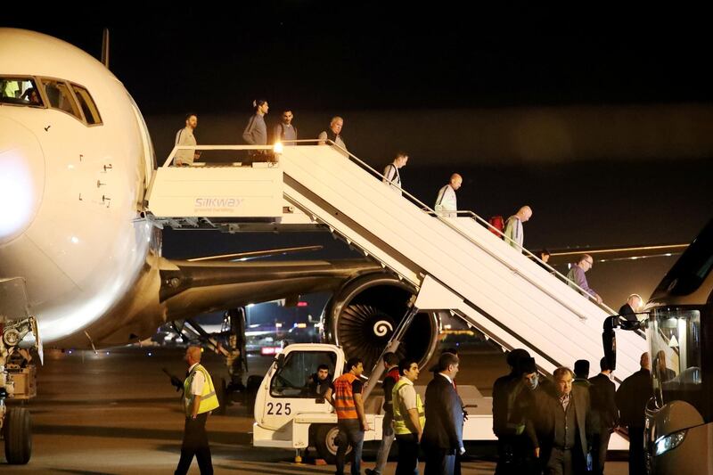 Chelsea players and staff step off the plane after arriving in Baku. Reuters