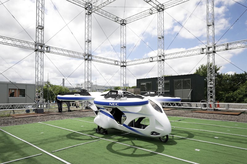 A prototype of NEC Corp.'s flying car sits on display during a demonstration at a testing site of the company's plant in Abiko, Chiba Prefecture, Japan, on Monday, Aug. 5, 2019. The vehicle is essentially a large drone with four propellers that’s capable of carrying people. The Japanese electronics maker demonstrated the machine, flying without a passenger, at a Tokyo suburb on Monday. Photographer: Kiyoshi Ota/Bloomberg