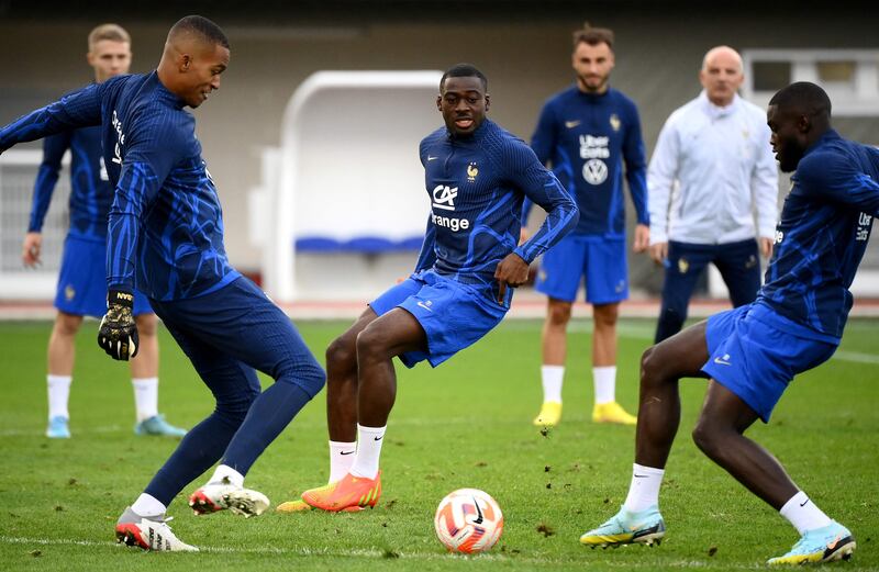 France midfielder Youssouf Fofan, centre, watches the ball. AFP