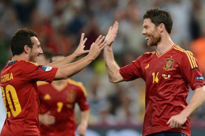 Spanish midfielder Xabi Alonso (R) celebrates with midfielder Santi Cazorla after he scored a goal during the Euro 2012 football championships quarter-final match Spain vs France on June 23, 2012 at the Donbass Arena in Donetsk.       AFP PHOTO / FRANCK FIFE

