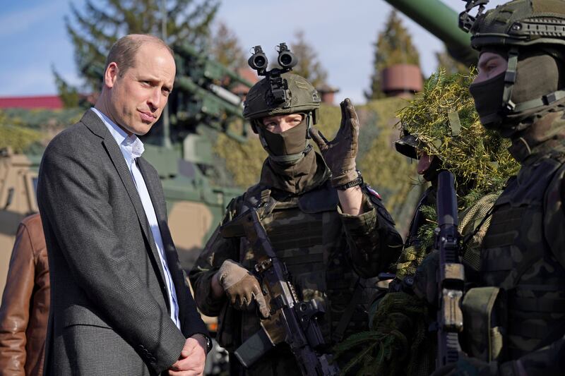 Prince William meets members of the Polish military. Getty