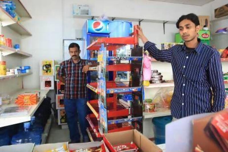 Business partners Mohamed Haneefa, left, and Naheef Murikkin Kattil say they cannot afford to pay between Dh200,000 and Dh300,000 to bring Abu Backar Grocery in line with the new regulations and both will now return to India. Ravindranath K / The National