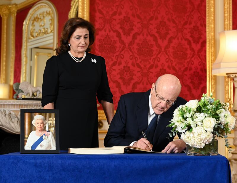 Lebanon's Prime Minister-designate Najib Mikati and his wife May sign a book of condolence at Lancaster House in London, after the death of Queen Elizabeth II. PA