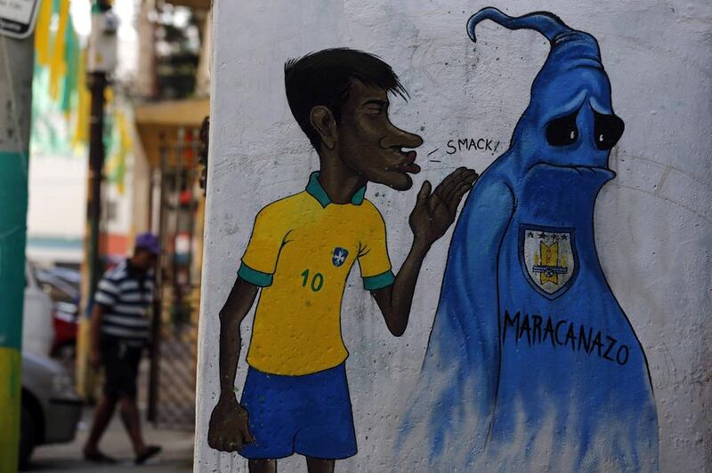 A man walks behind a graffiti depicting Brazilian soccer player Neymar and a phantom representing the Uruguayan soccer team, who won the 1950 World Cup in Brazil, in Rio de Janeiro on May 14, 2014. Rio de Janeiro is one of the host cities for the 2014 World Cup in Brazil. Sergio Moraes / Reuters