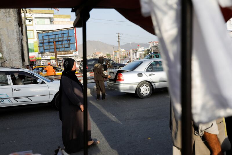 A Taliban fighter checks a car at the site of a blast in Kabul, Afghanistan, this month. Reuters