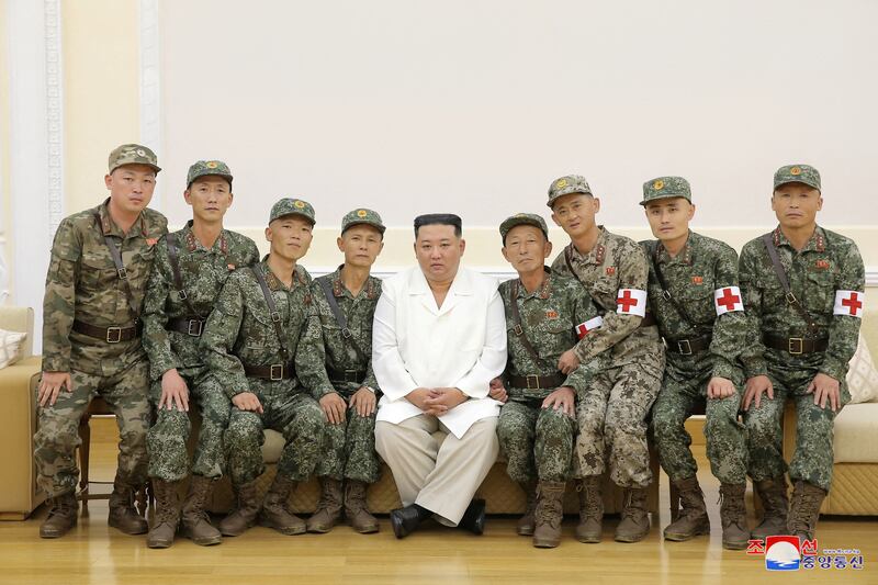 North Korea's leader Kim Jong Un poses for a photo with  Korean People's Army medics during a meeting to recognise their contributions in fighting the coronavirus disease (COVID-19) pandemic in Pyongyang, North Korea, August 18, 2022 in this photo released by North Korea's Korean Central News Agency (KCNA).  KCNA via REUTERS    ATTENTION EDITORS - THIS IMAGE WAS PROVIDED BY A THIRD PARTY.  REUTERS IS UNABLE TO INDEPENDENTLY VERIFY THIS IMAGE.  NO THIRD PARTY SALES.  SOUTH KOREA OUT.  NO COMMERCIAL OR EDITORIAL SALES IN SOUTH KOREA.      TPX IMAGES OF THE DAY