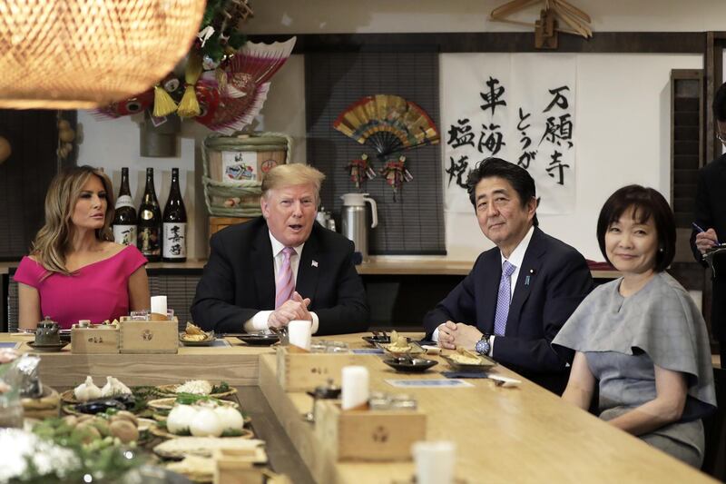 U.S. President Donald Trump, second left, speaks while sitting at a counter with First Lady Melania Trump, left, Shinzo Abe, Japan's prime minister, second right, and Akie Abe, wife of Shinzo Abe, during a dinner at the Inakaya restaurant in the Roppongi district of Tokyo, Japan, on Sunday, May 26, 2019. Trump said the U.S. is making "great progress" in trade negotiations with Japan even though a deal could come only after the latter's elections in July.  Photographer: Kiyoshi Ota/Bloomberg