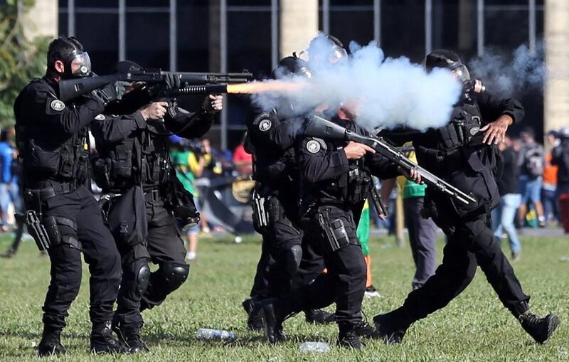 Riot police fire during clashes with demonstrators during a protest against the Brazilian president Michel Temer in Brasilia. Paulo Whitaker / Reuters