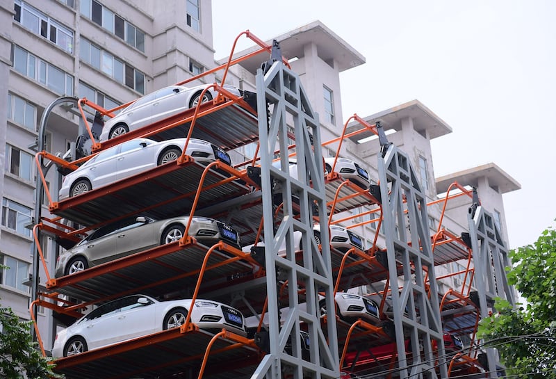 This photo taken on June 19, 2017 shows a ten-storey, three dimensional car park structure located between residential buildings in Shenyang, in China's Liaoning province.
The structures can take nearly 40 vehicles and are becoming more common as more Chinese abandon public transport and drive. / AFP PHOTO / STR / China OUT