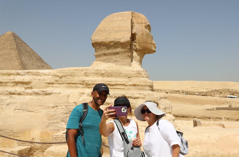 Tourists visit the Giza Pyramids and the Sphinx, in Egypt. EPA