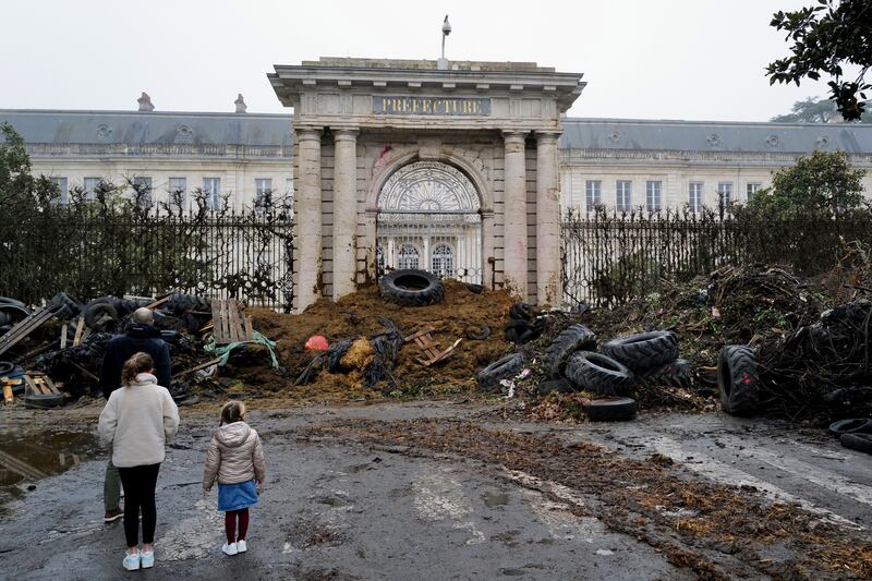 Slurry, manure and tyres dumped by farmers at the entrance of the local state administration building, in Agen, south-western France. AP