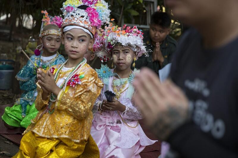 Kemachart and other novices take part in a prayer ceremony at Wat Supan Rangsri in Mae Sariang, Thailand. Han, 10, and Kemachart, 11, are neighbors in Chiang Mai’s ethnic Tai Yai (Shan) community who have travelled to Mae Sariang near the Burmese border for the Poy Sang Long ordination ceremony where their family roots and traditional culture remain strong. Poy Sang Long is a Buddhist novice ordination ceremony of the Shan people or Tai Yai, an ethnic group of Shan State in Myanmar and northern Thailand. Young boys aged between 7 and 14 are ordained as novices to learn the Buddhist doctrines. Taylor Weidman / Getty Images