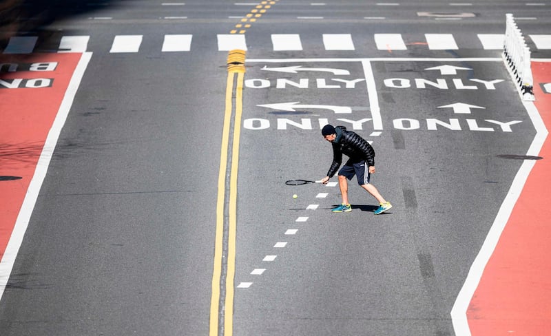 A man plays tennis on  42nd Street  in New York City.  AFP