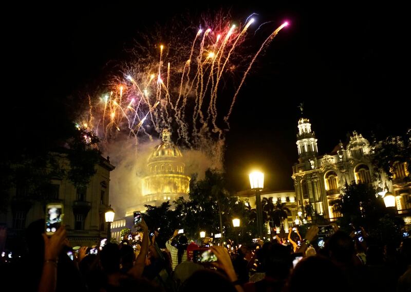 People take pictures of the fireworks at the Capitol during a gala as part of the celebration of the 500 years of the city in Havana, Cuba.  AP